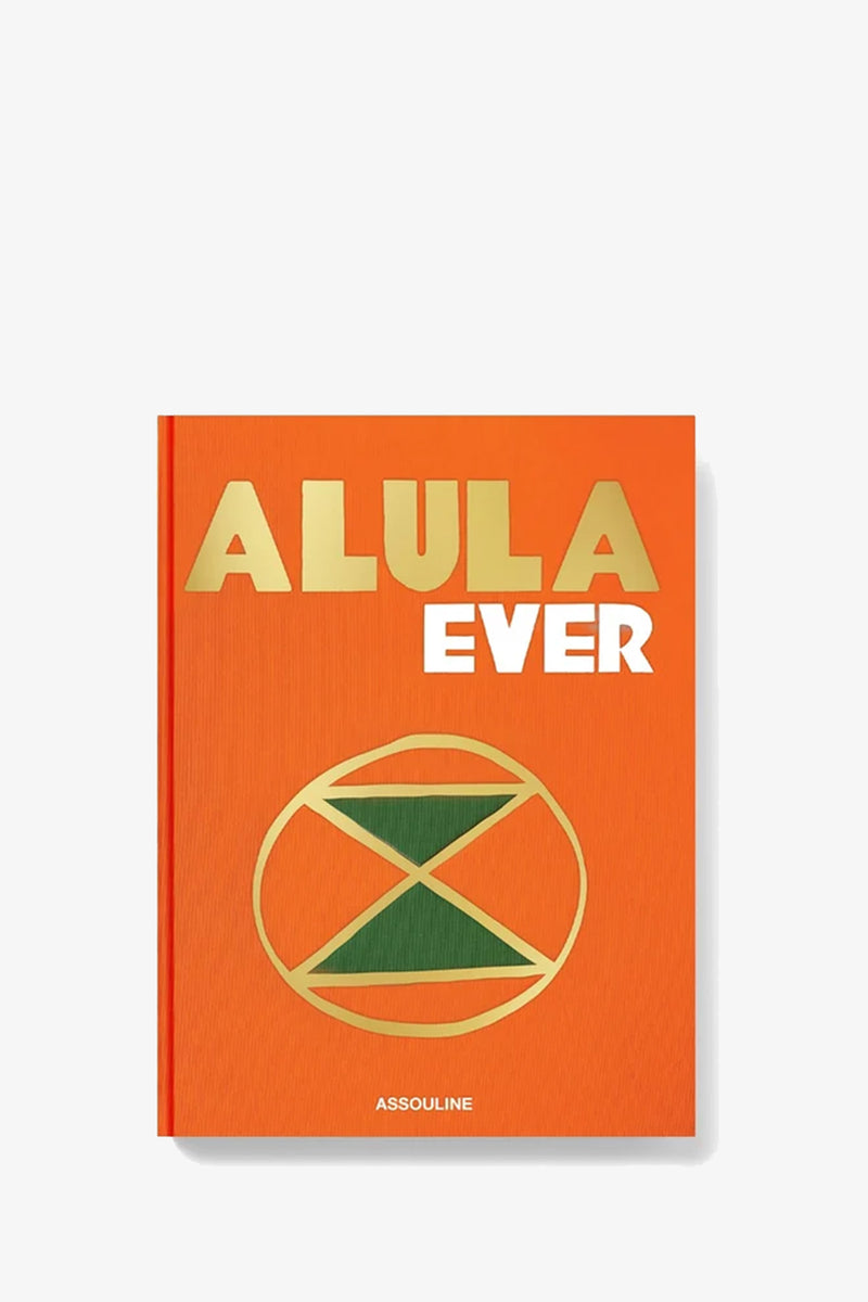 A vibrant orange cover distinguishes the Assouline Alula Ever Book, featuring gold and white text reading “ALULA EVER” and a green geometric pattern within a golden circle, with the publisher ASSOULINE’s name at the bottom.