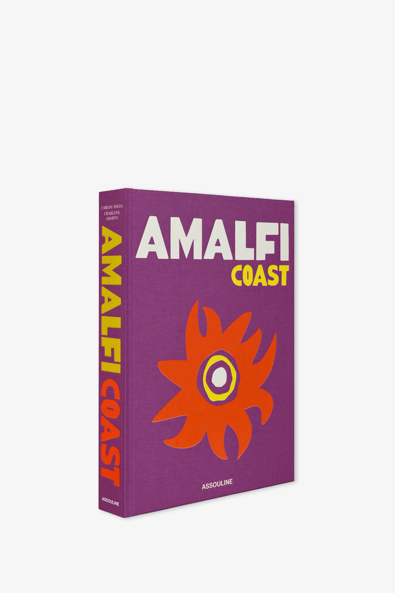 Assouline Amalfi Coast Book featuring a vibrant purple cover with bold white and yellow text, accented by an orange abstract flower design. The spine is yellow and red, showcasing the title in large letters.