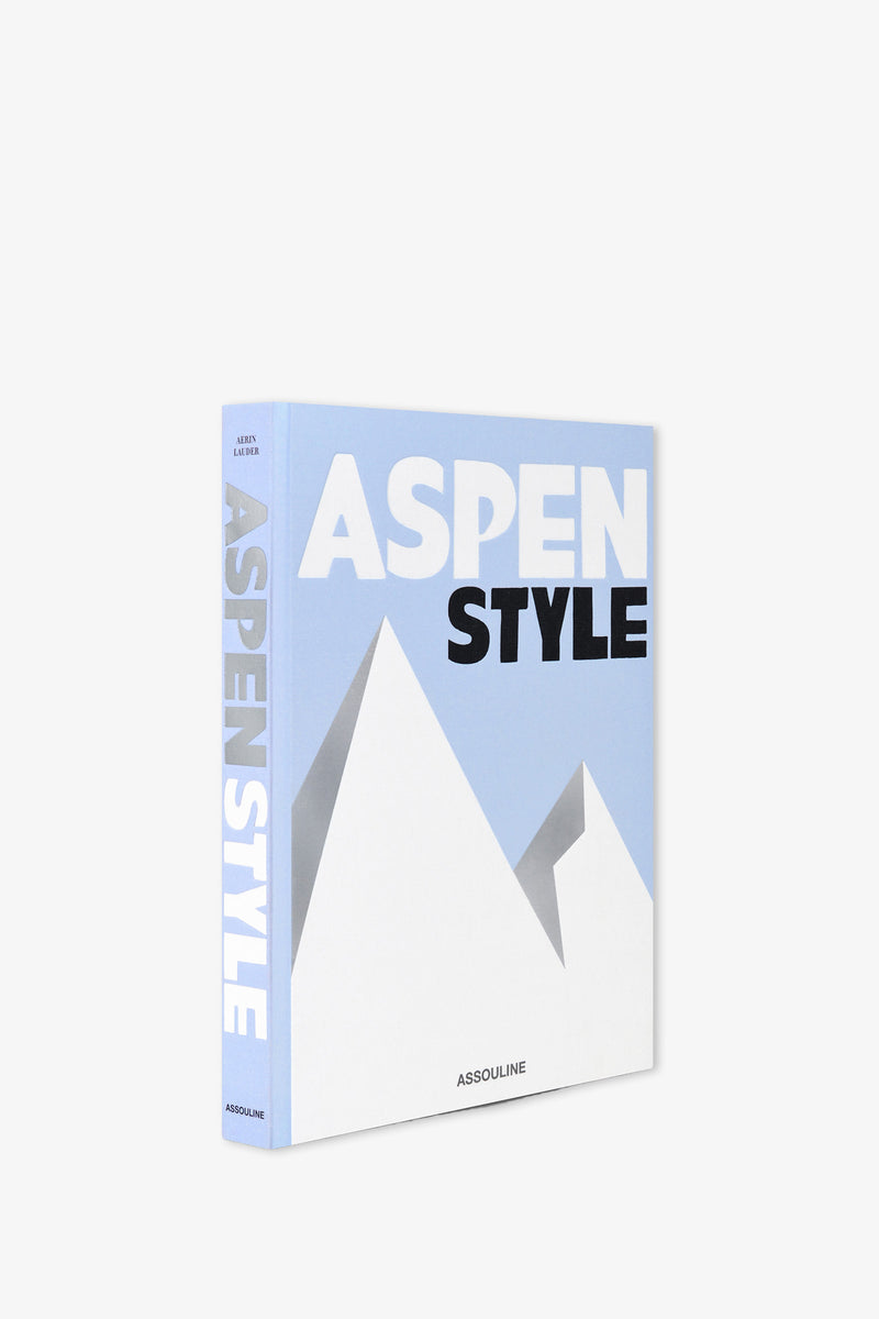 A light blue and white Assouline Aspen Style Book featuring minimalist mountain graphics on the cover and spine, with the publisher's name, Assouline, displayed at the bottom.