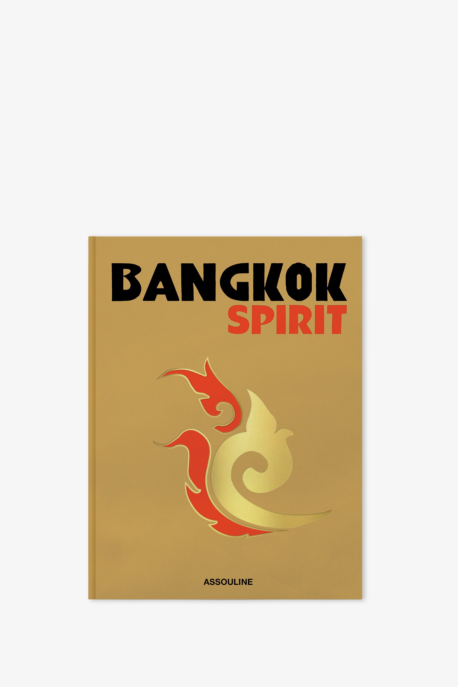 The Assouline Bangkok Spirit Book features a gold cover with striking black and orange "Bangkok Spirit" text, a stylized flame or bird design, and the publisher's name, Assouline, displayed at the bottom.