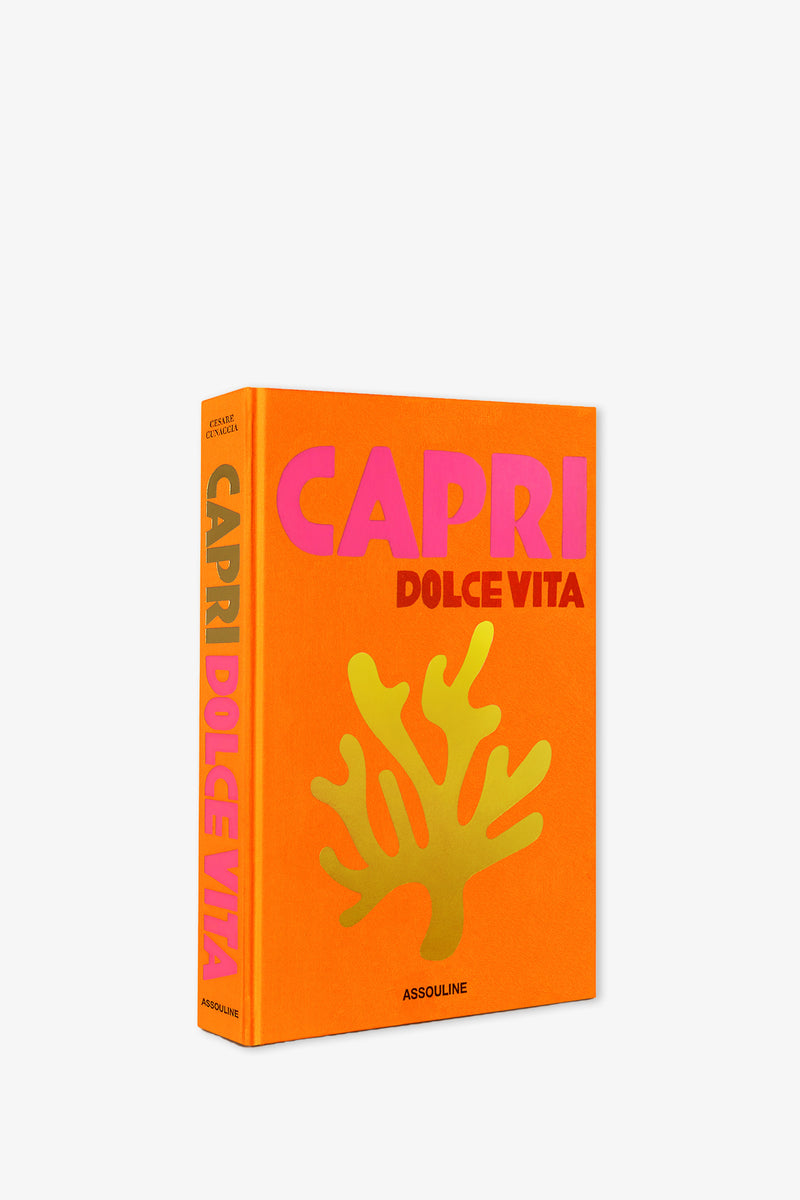 Assouline Capri Dolce Vita Book with an orange cover featuring the title in pink and red letters, a gold coral illustration, and visible author and Assouline publisher details.