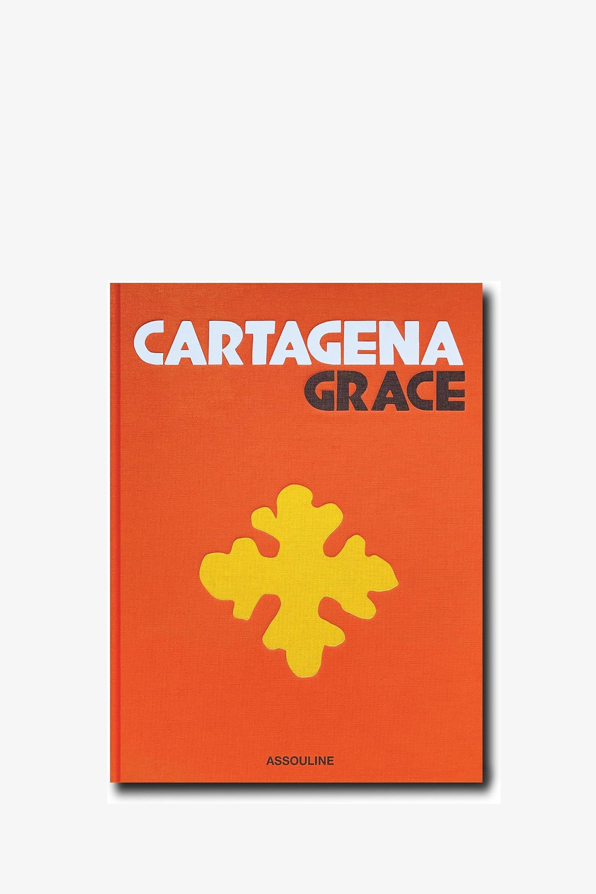 An orange Assouline Cartagena Grace Book featuring a large yellow abstract shape on the cover and “ASSOULINE” printed at the bottom.