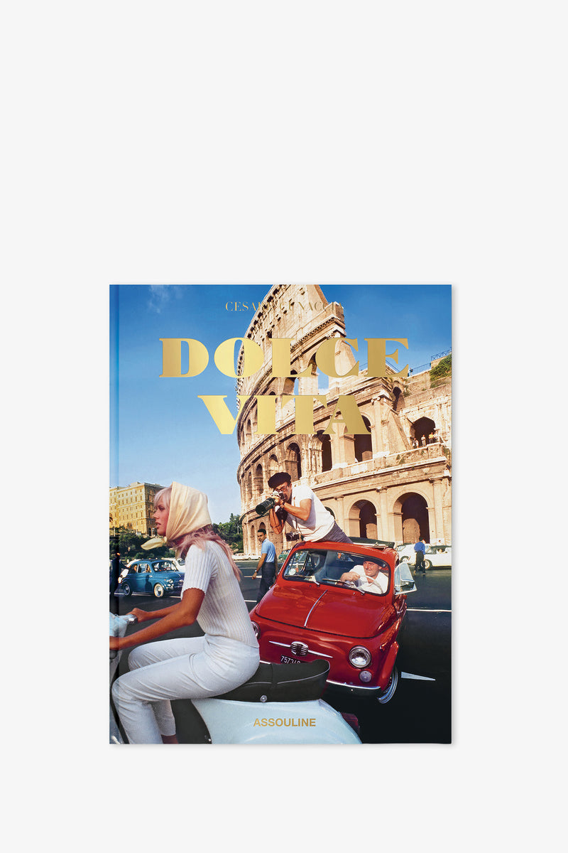 The Assouline Dolce Vita Book features a cover with a vintage photograph of people in classic cars by the Colosseum in Rome, “Dolce Vita” displayed in bold yellow letters, and the Assouline logo at the bottom.