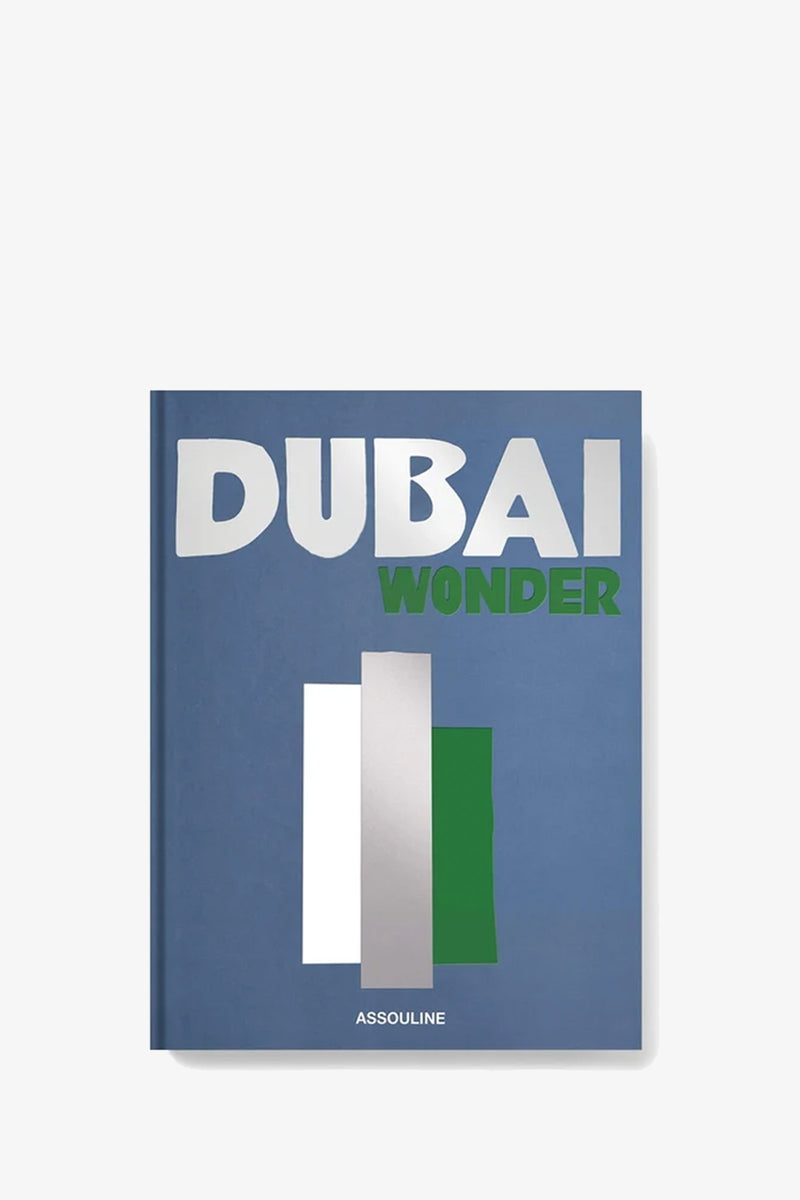 A blue book cover for Assouline Dubai Wonder features the title in bold white and green letters, with vertical silver, white, and green rectangles below; “ASSOULINE” appears at the bottom.