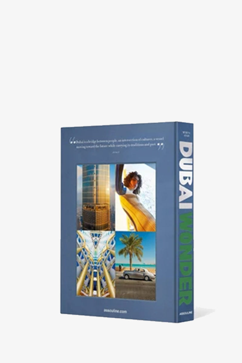 An upright Assouline Dubai Wonder book with a blue cover featuring images of modern architecture, a woman, and palm trees, displayed against a plain white background.