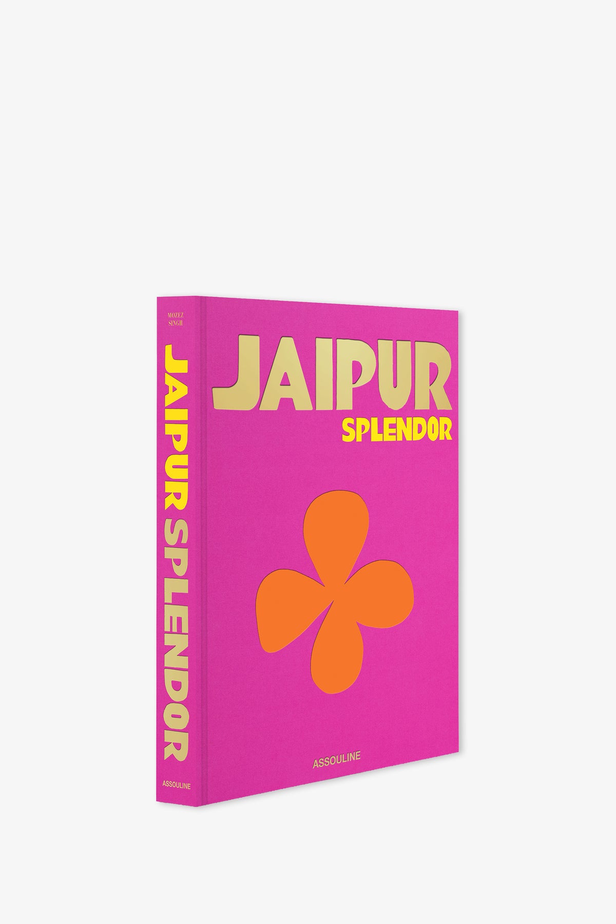 A vibrant pink Assouline Jaipur Splendor Book featuring "Jaipur Splendor" in gold and yellow lettering, adorned with an orange flower graphic on both the cover and spine. The publisher's name, Assouline, appears at the bottom of the cover.