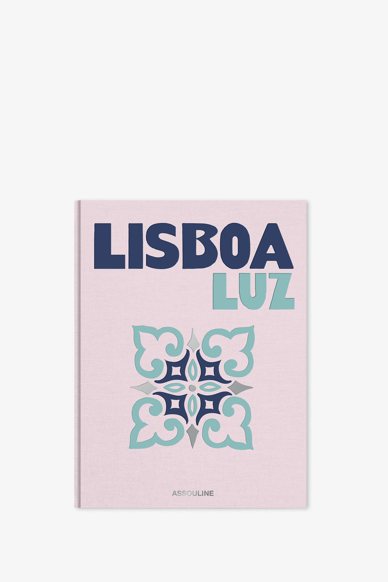 Assouline Lisboa Luz Book features a pale pink cover adorned with bold blue and light blue text, a decorative tile motif in teal and navy, and the Assouline logo displayed at the bottom.