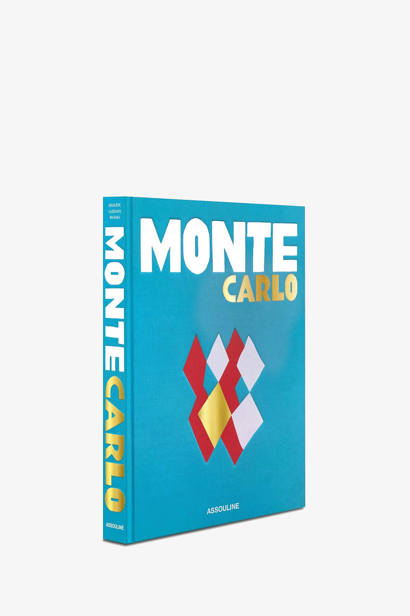 The Assouline Monte Carlo Book features a blue cover with geometric red, white, and yellow shapes.