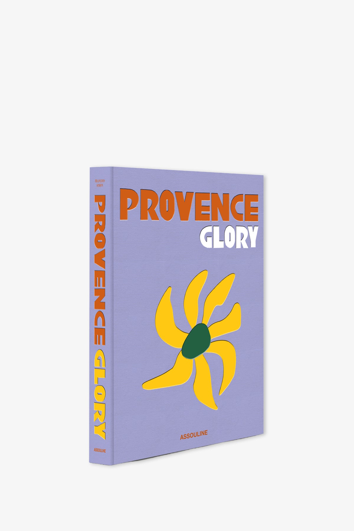 The Assouline Provence Glory Book has a lavender cover with bold orange and white text, a minimalist yellow sun illustration, and “Assouline” printed at the bottom.