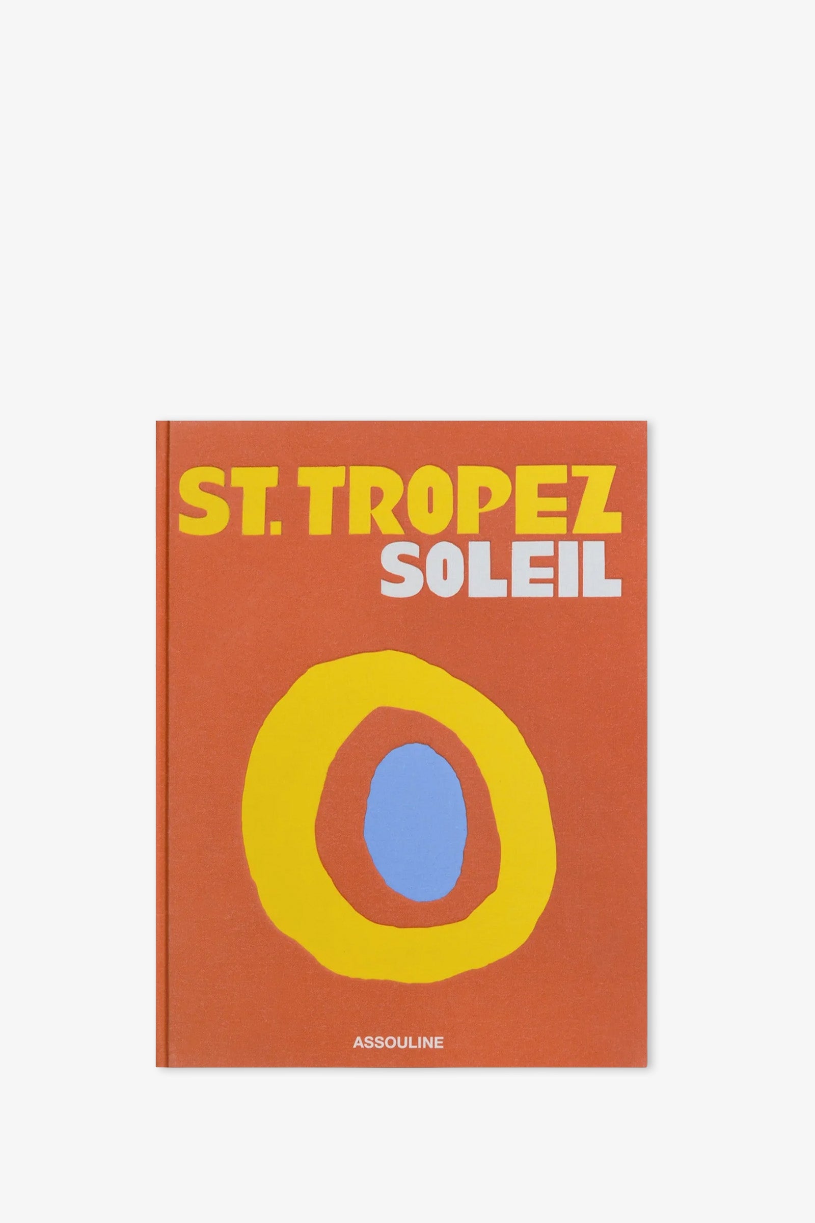 The Assouline St. Tropez Soleil Book features bold yellow and white text on the cover, with a striking yellow and blue abstract sun design set against an orange background. The publisher, ASSOULINE, is printed at the bottom.