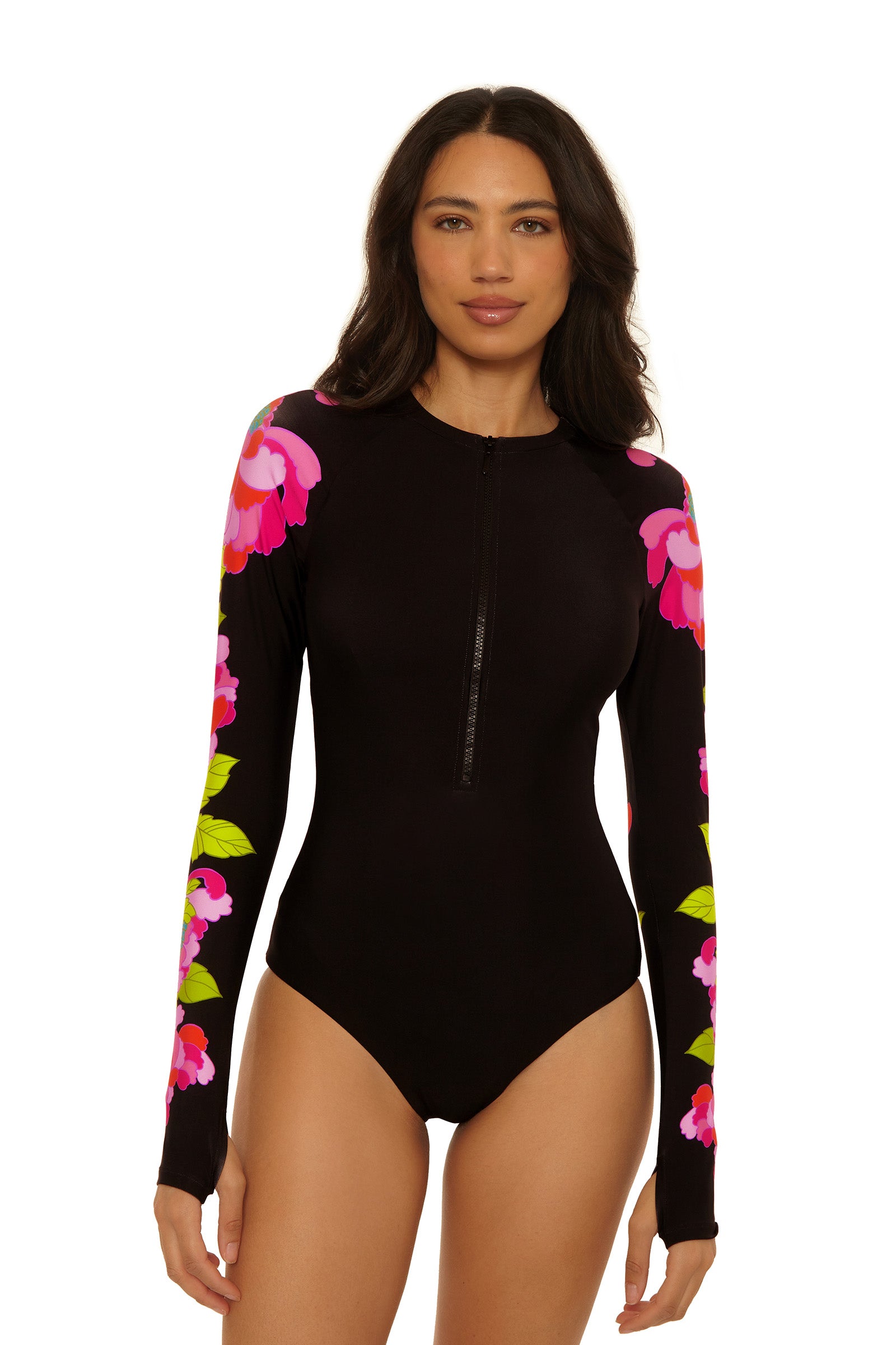 A woman wears the Long-Sleeve Zip-Up Paddlesuit in Bougainvillea Swim Knit, featuring pink floral patterns on the sleeves and shoulders, standing against a plain white background.