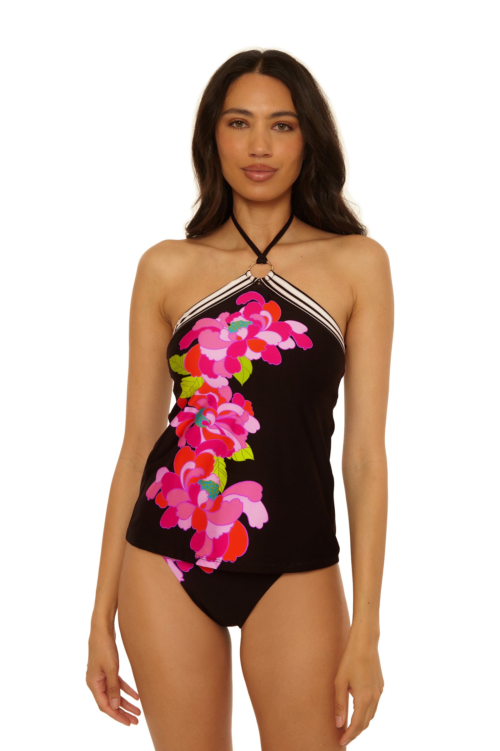 A woman with long dark hair models the Reversible Tankini Swim Top in Bougainvillea Swim Knit, featuring a vibrant floral front, paired with black bikini bottoms against a plain white background.