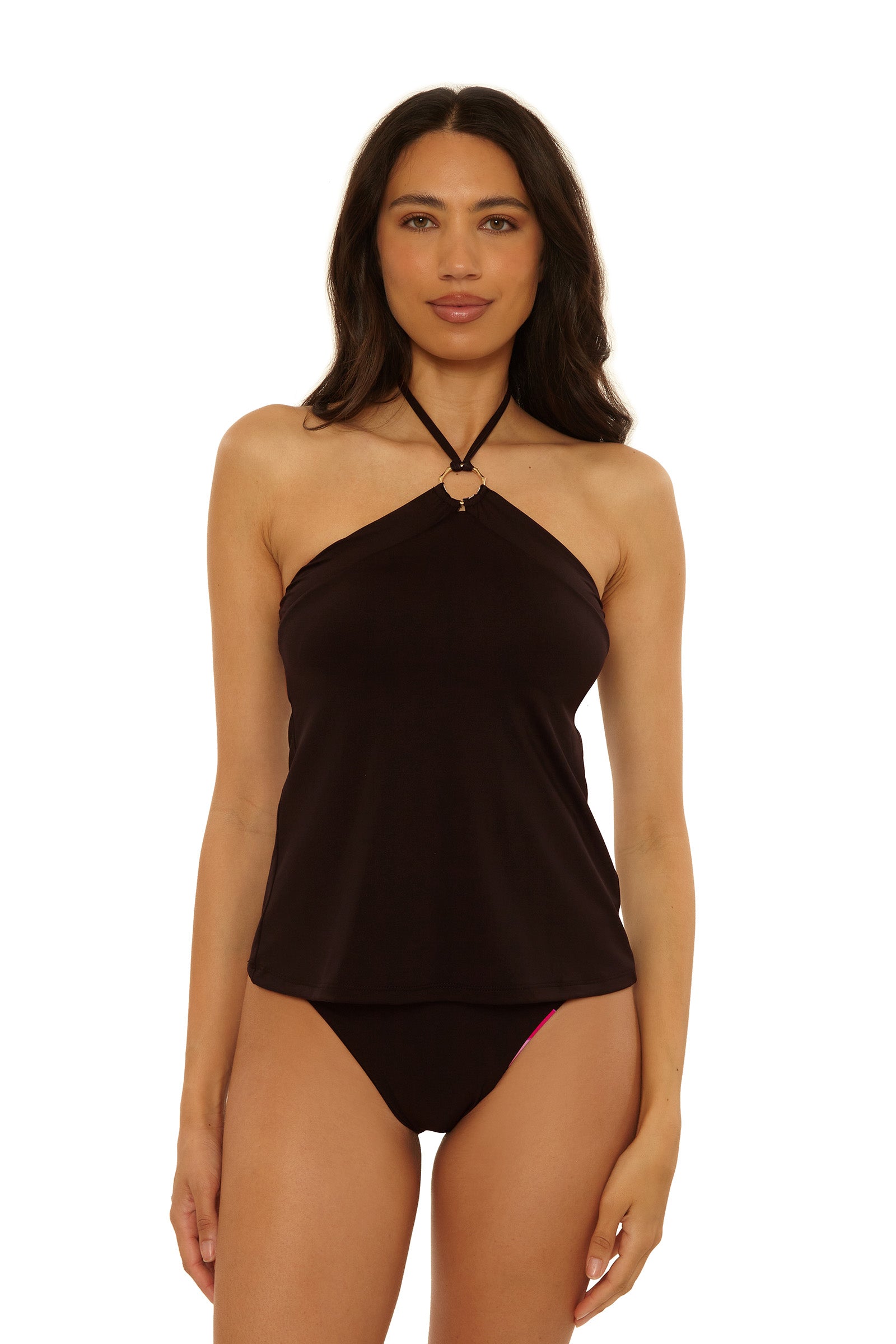 A woman with long dark hair wears the Reversible Tankini Swim Top - Bougainvillea with matching bikini bottoms, standing against a plain white background.