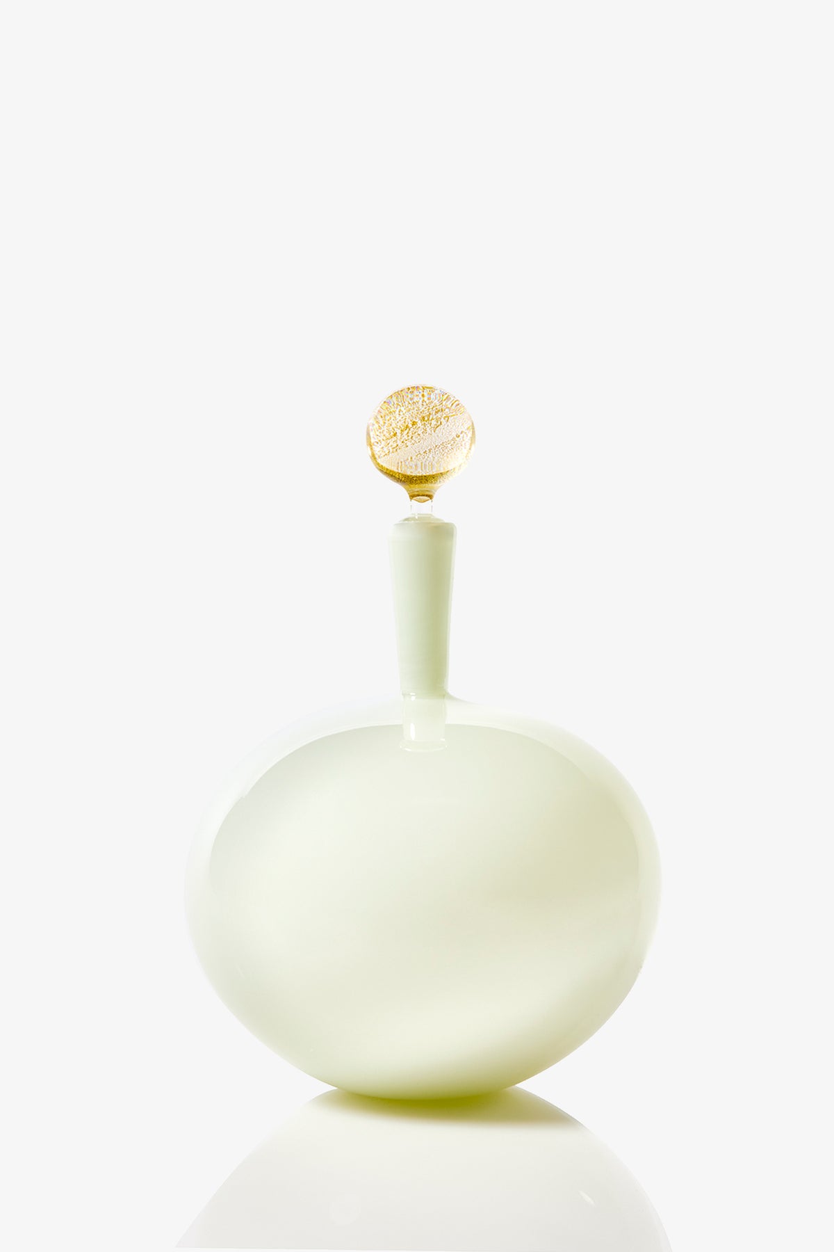The Carmella Barware Low Round features a glossy, pale green, round design with a smooth curved body and a gold-accented stopper, displayed against a plain white background.