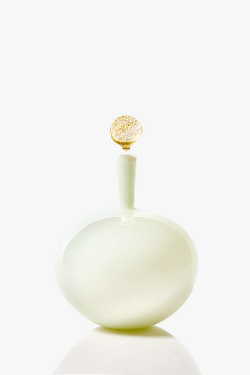 The Carmella Barware Low Round features a glossy, pale green, round design with a smooth curved body and a gold-accented stopper, displayed against a plain white background.