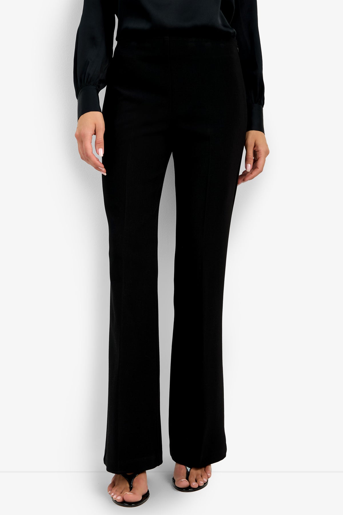 A person wearing the Chimayo Pant and a black long-sleeve blouse stands against a white background, shown from shoulders down, with open-toe black heels visible.