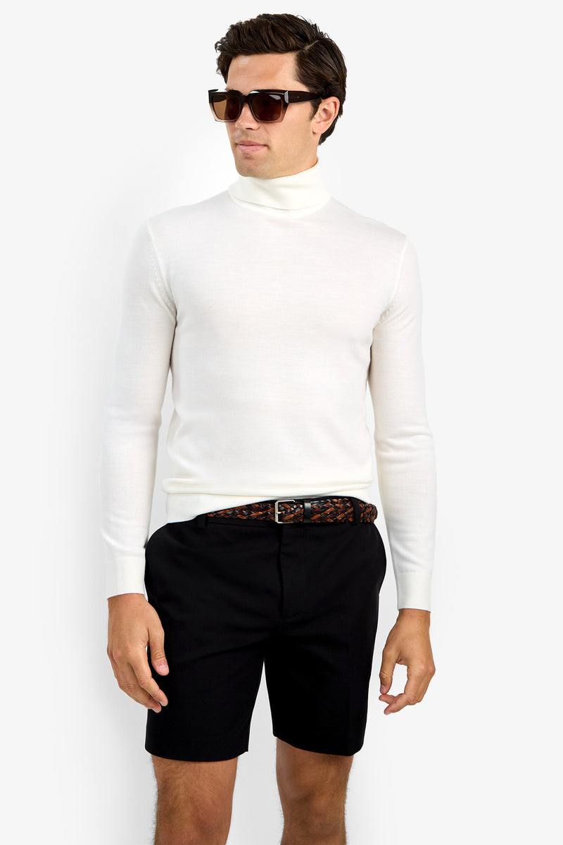 A man in dark sunglasses, black shorts, a brown patterned belt, and the Roy Long Sleeve Turtleneck stands against a plain white background.