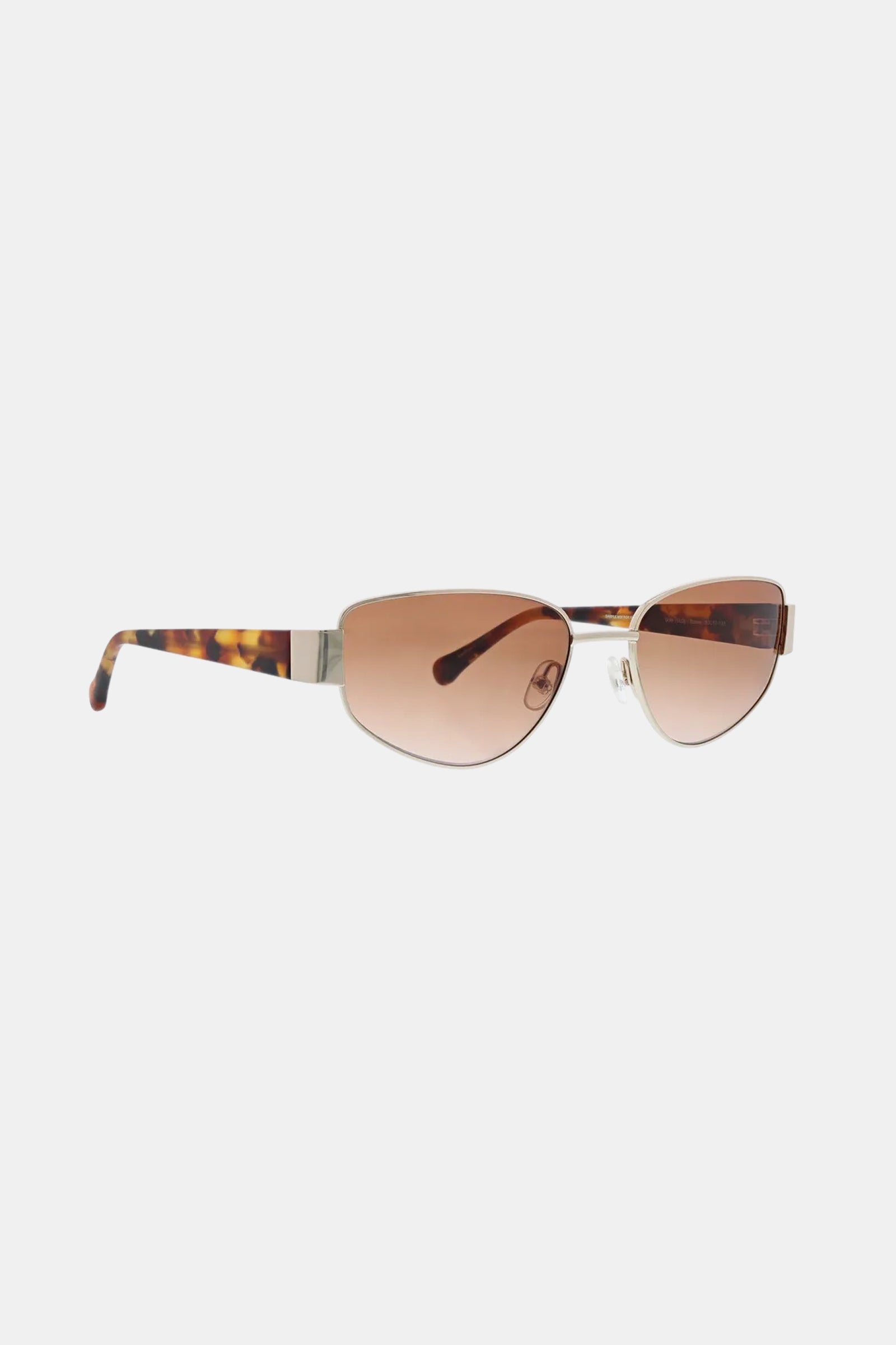 The Dunes Sunglass features brown oval-shaped tinted lenses, a slim metal bridge, and tortoiseshell-patterned temples. Displayed against a plain light background.