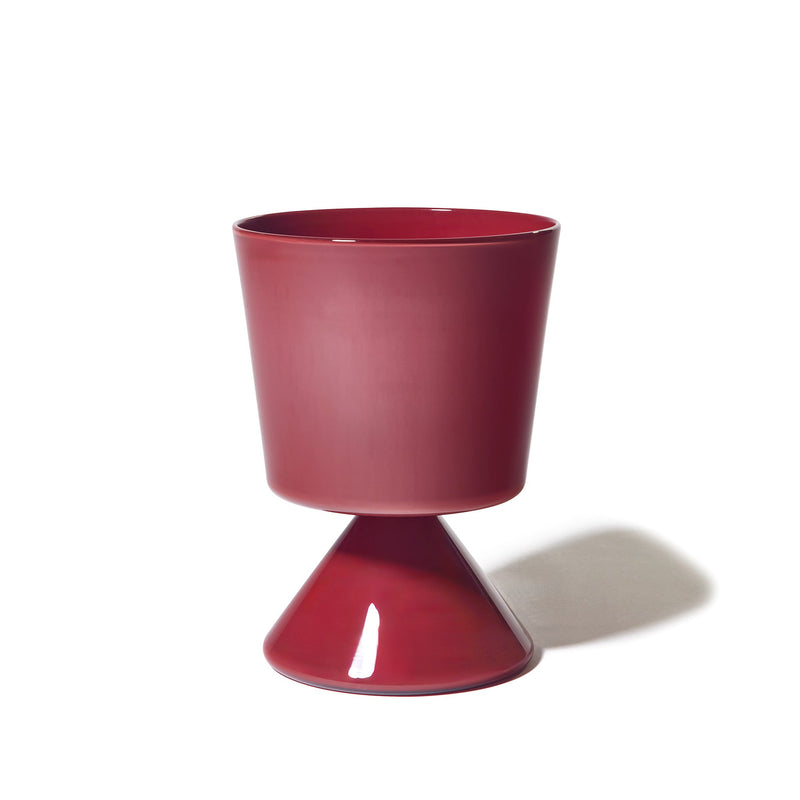 A contemporary Fiorelli Low Taper planter in a glossy sienna finish, featuring a cylindrical top and cone-shaped base, displayed against a white background with a shadow cast to the right.