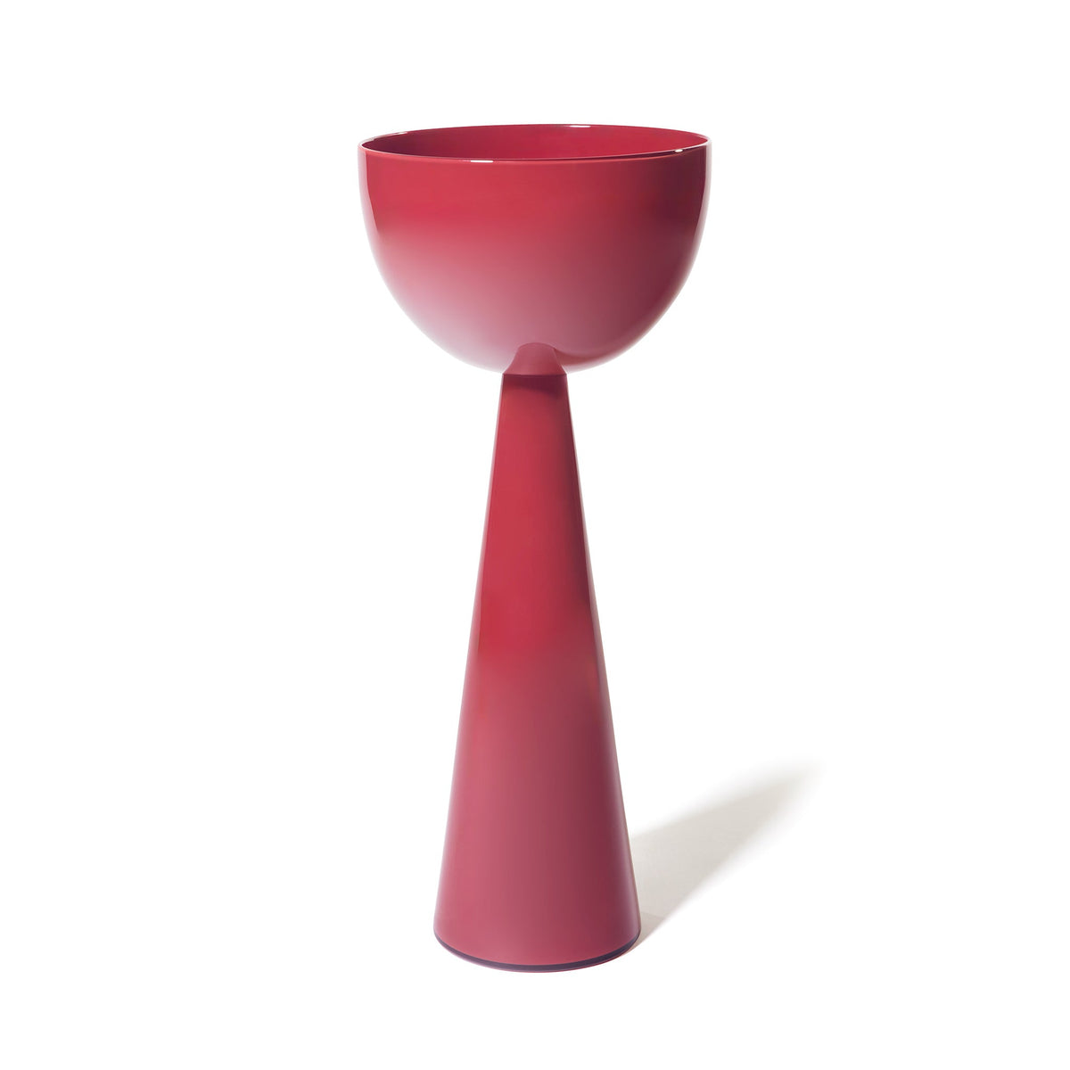 The Fiorelli Tall Bowl, featuring a modern glossy deep red finish, sits atop a matching tall conical base, creating a minimalist goblet-like silhouette against a plain white background.