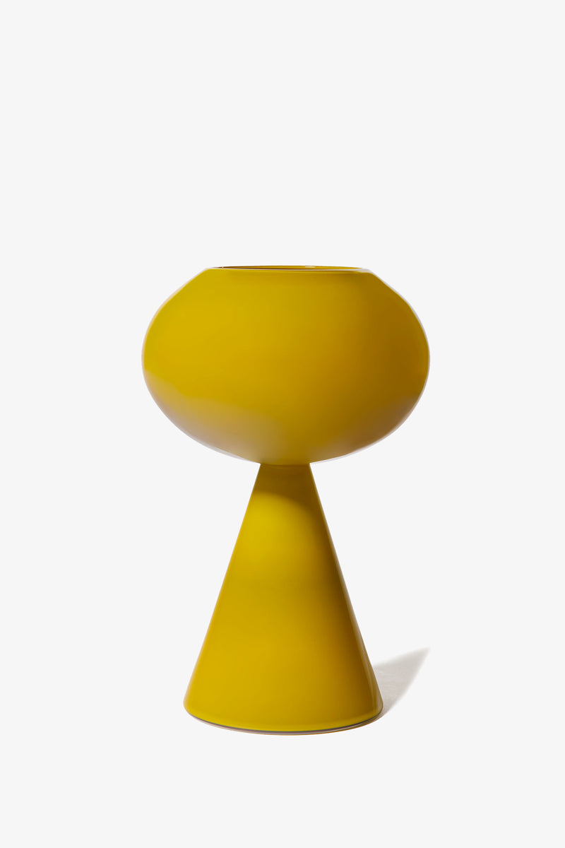 Introducing the Fiorelli Concave: a modern yellow vase featuring a rounded top and cone-shaped base, displayed against a plain white background.