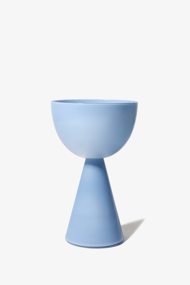 The Fiorelli Low Bowl is a modern ceramic planter in pastel blue, featuring a bowl-shaped top and a conical base, photographed against a plain white background.