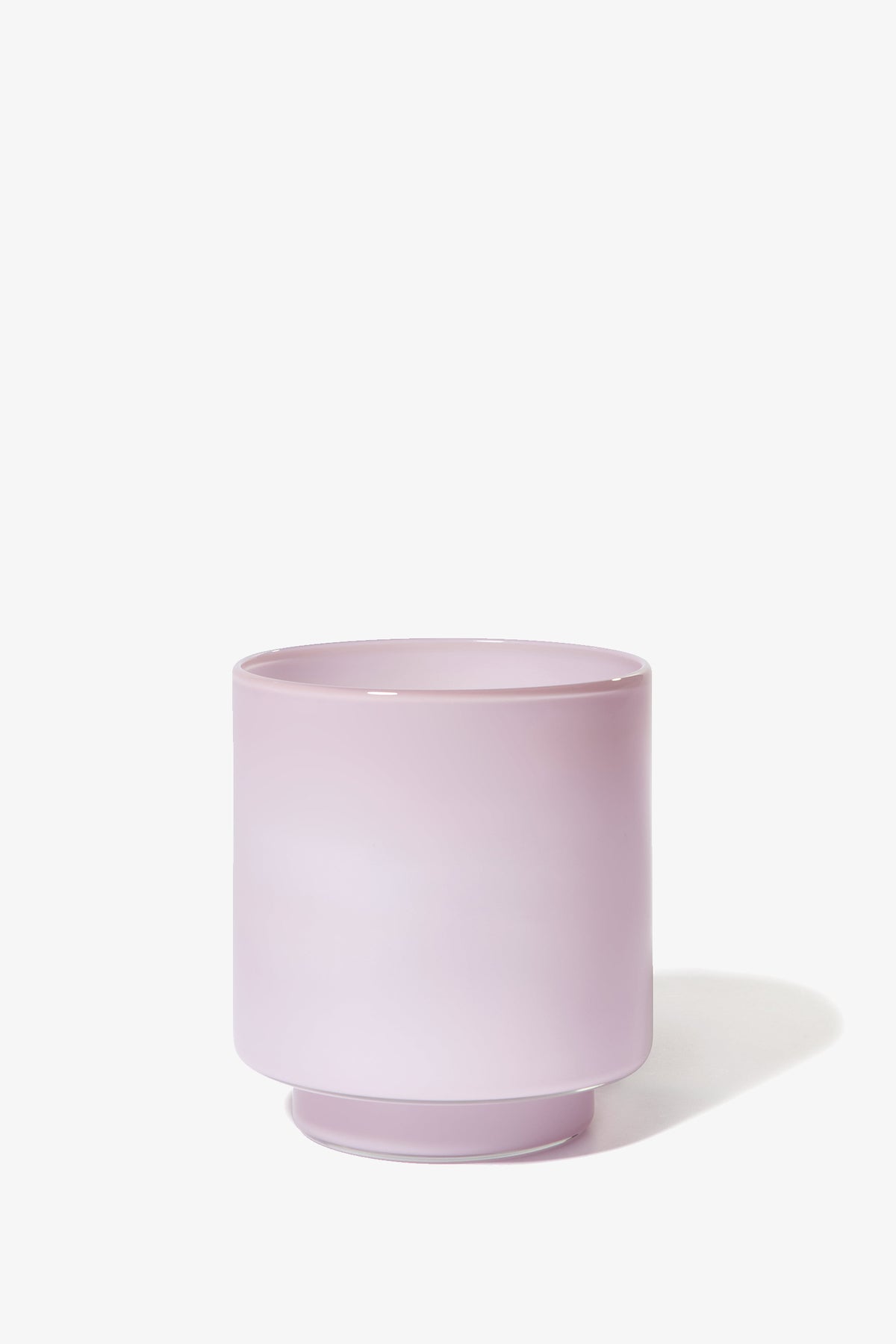 The Fiorelli Low Container is a light pink, cylindrical ceramic planter with a small base, shown on a white background.