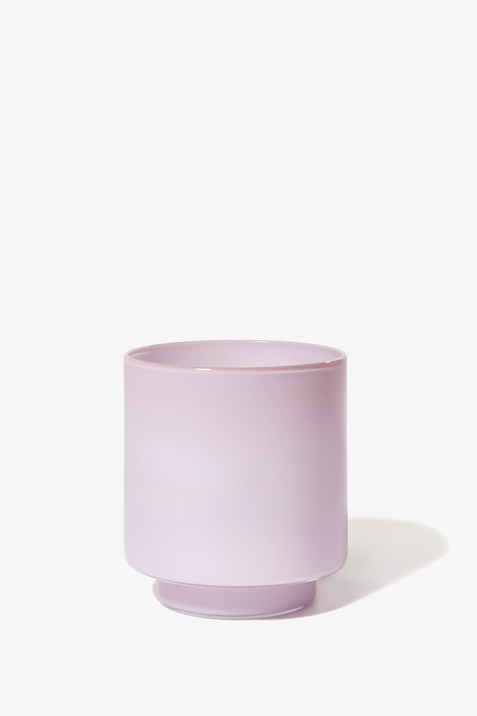 The Fiorelli Low Container is a light pink, cylindrical ceramic planter with a small base, shown on a white background.