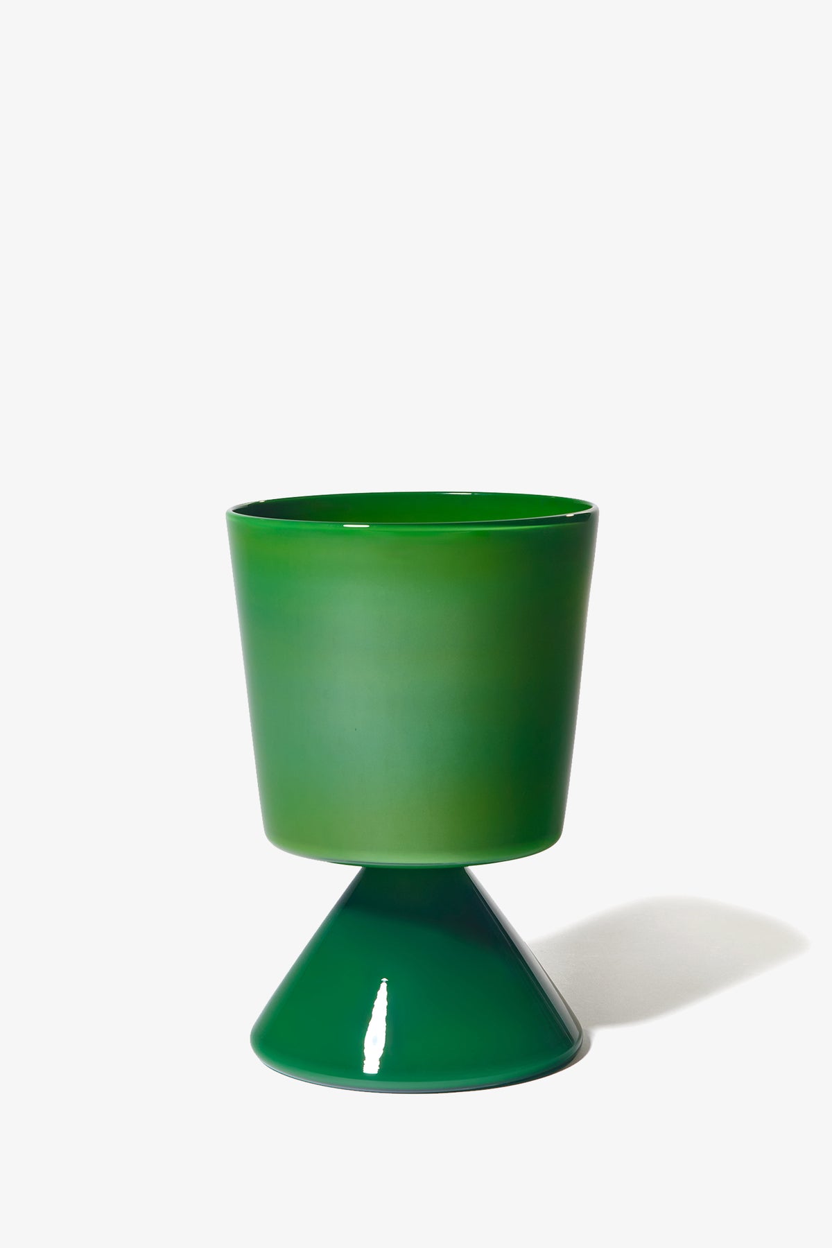 A modern Fiorelli Low Taper planter in glossy green, featuring a wide cylindrical top and cone-shaped base, set against a white background with a faint shadow on the right.