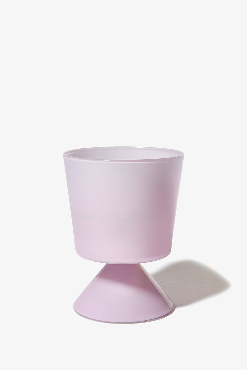 The Fiorelli Low Taper planter in pastel pink features a wide, round top and a conical base, displayed on a white background with a subtle shadow cast to the right.
