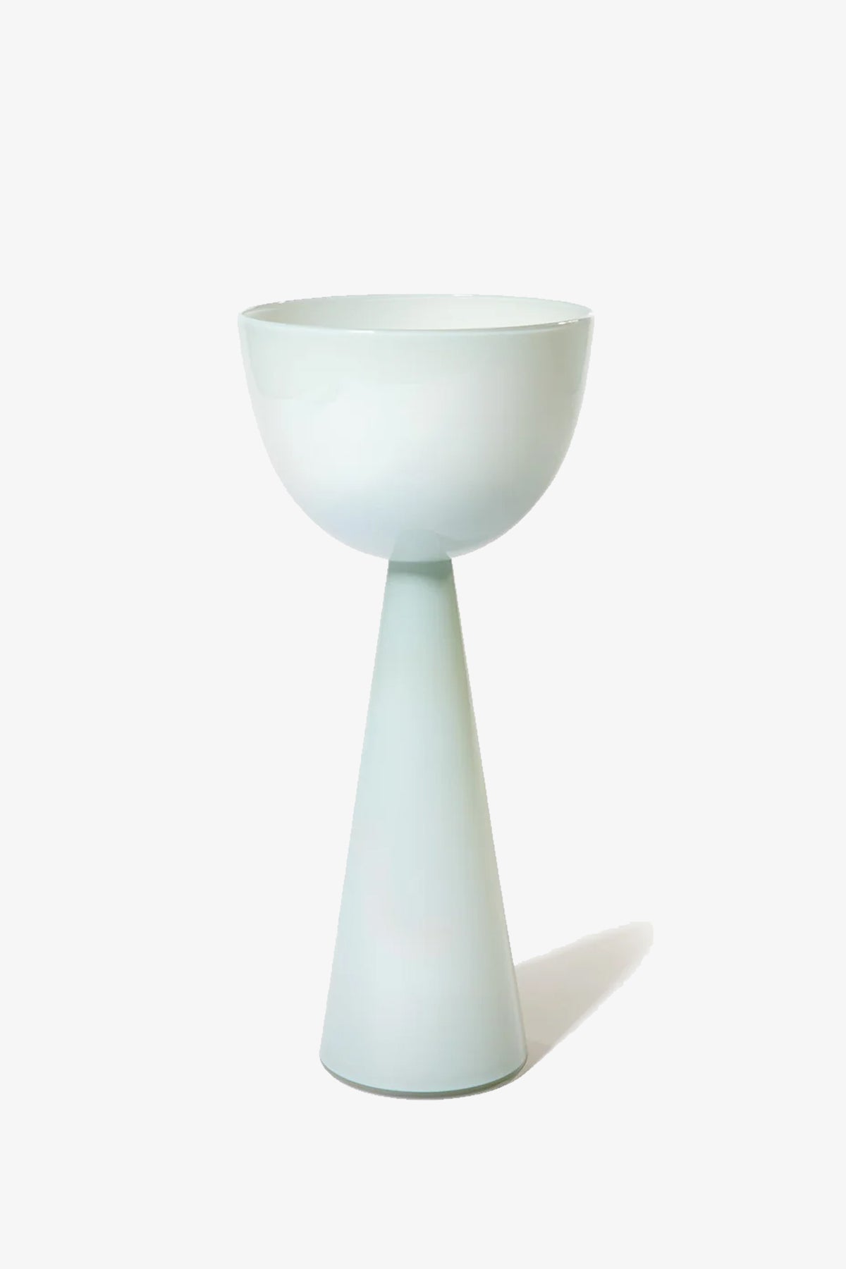 The Fiorelli Tall Bowl is a minimalist white ceramic goblet featuring a wide bowl atop a tall, narrow conical base, set against a plain white background.