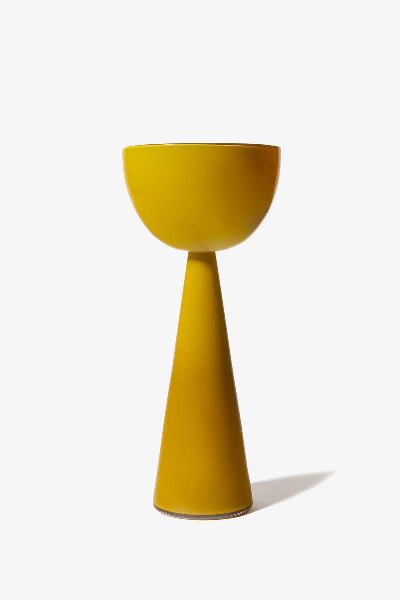The Fiorelli Tall Bowl is a modern yellow side table featuring a bowl-shaped top and conical base, displayed against a plain white background.