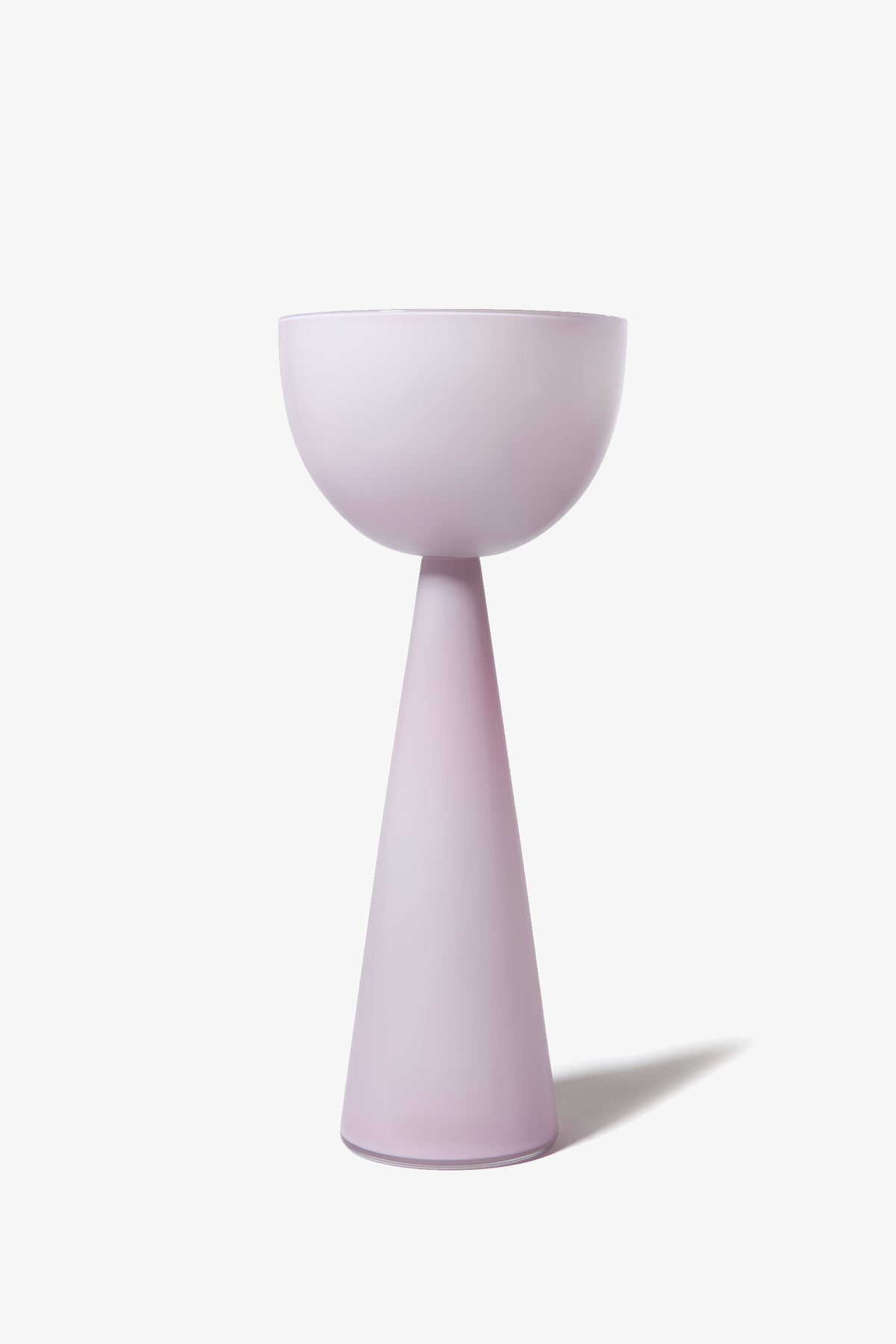 The Fiorelli Tall Bowl features a minimalist, modern pedestal design with a wide bowl-shaped top and a conical base, both finished in a soft pastel lavender color, set against a plain white background.