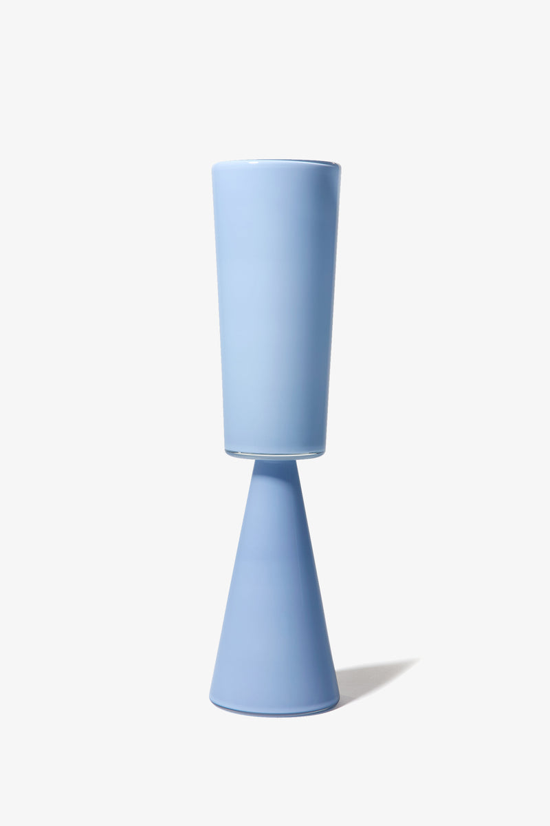 The Fiorelli Tall Cylinder is a light blue ceramic vase featuring a cylindrical top and a conical base, photographed against a plain white background.