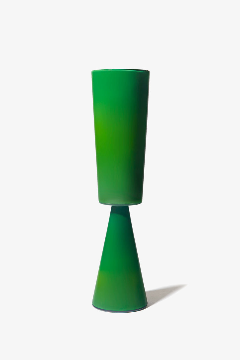 The Fiorelli Tall Cylinder is a green ceramic vase featuring a tall cylindrical top and a cone-shaped base, shown standing upright against a plain white background.