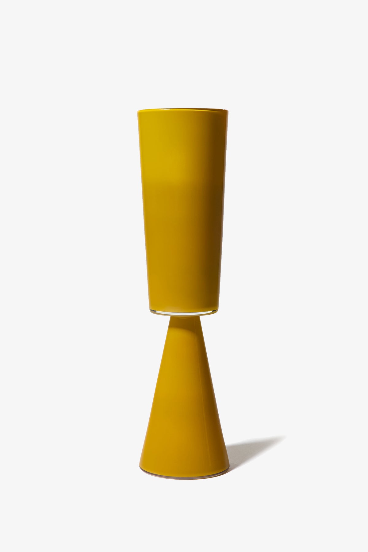 The Fiorelli Tall Cylinder is a modern yellow ceramic vase featuring a tall cylindrical top and a conical base, displayed upright against a plain white background.