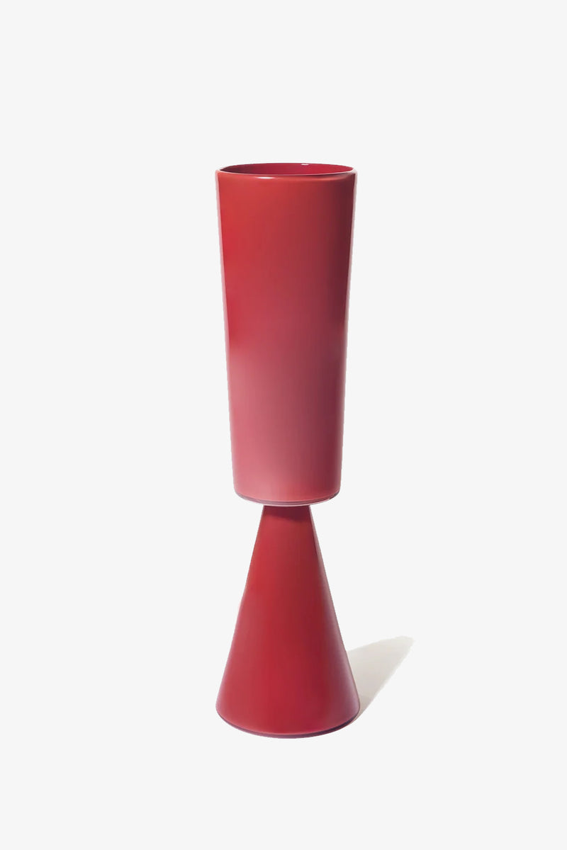 The Fiorelli Tall Cylinder is a modern, minimalist red vase featuring a tall cylindrical top and a conical base, shown against a plain white background.