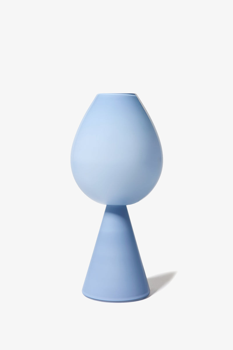 The Fiorelli Tulip is a modern, minimalist blue vase featuring a rounded top and conical base, showcased against a plain white background.