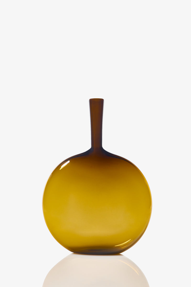The Flask Angelic Bottle is a round, flat-bottomed yellow glass vase with a narrow, elongated neck and smooth, glossy surface, displayed against a white background.