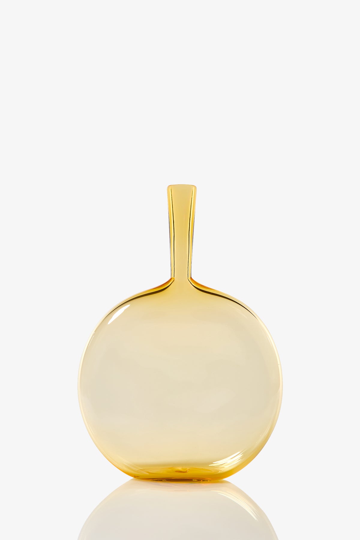 The Flask Angelic Bottle is a round, transparent yellow glass vase with a narrow, straight neck and smooth glossy finish. Its modern, minimalist design stands out elegantly against a plain white background.