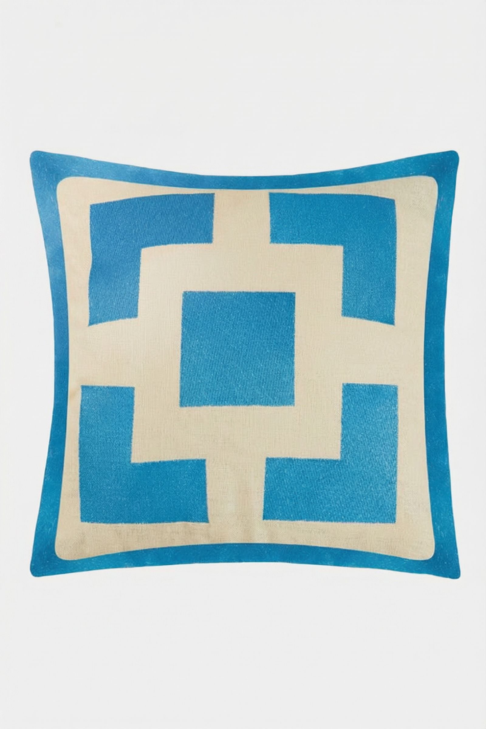 The Palm Springs Block Embroidered Pillow is a 20"x20" TRINA TURK HOME cover with a geometric blue and cream central square design, angular blue shapes on cream, and includes a plush down feather insert.