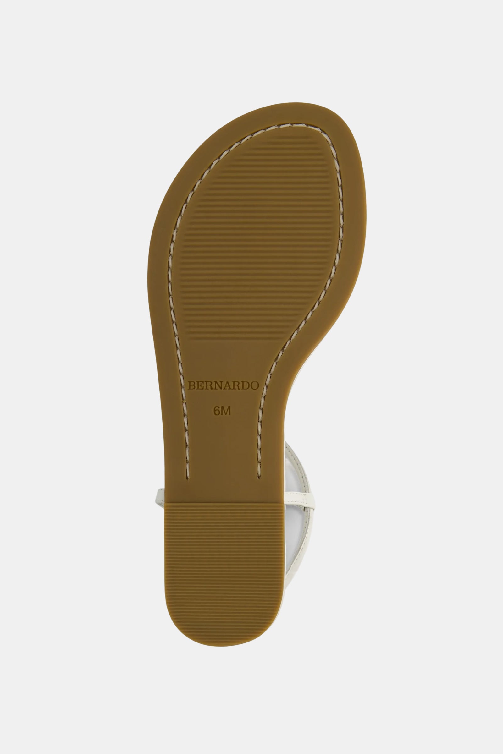 The image shows the sole of the Hercu Sandal with a brown, textured rubber bottom, white stitching around the edge, and "BERNARDO 6M" stamped near the heel. Part of the sandal strap is visible at the top.