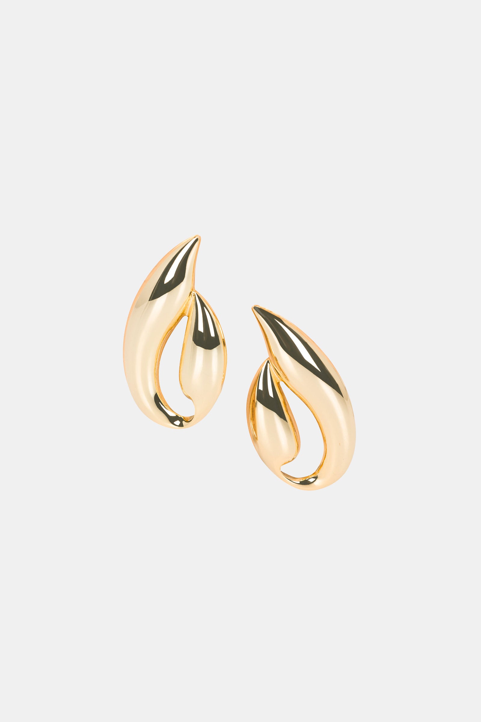 The Abstract Post Earring features shiny gold, abstract-shaped designs with smooth curves, displayed on a plain white background.