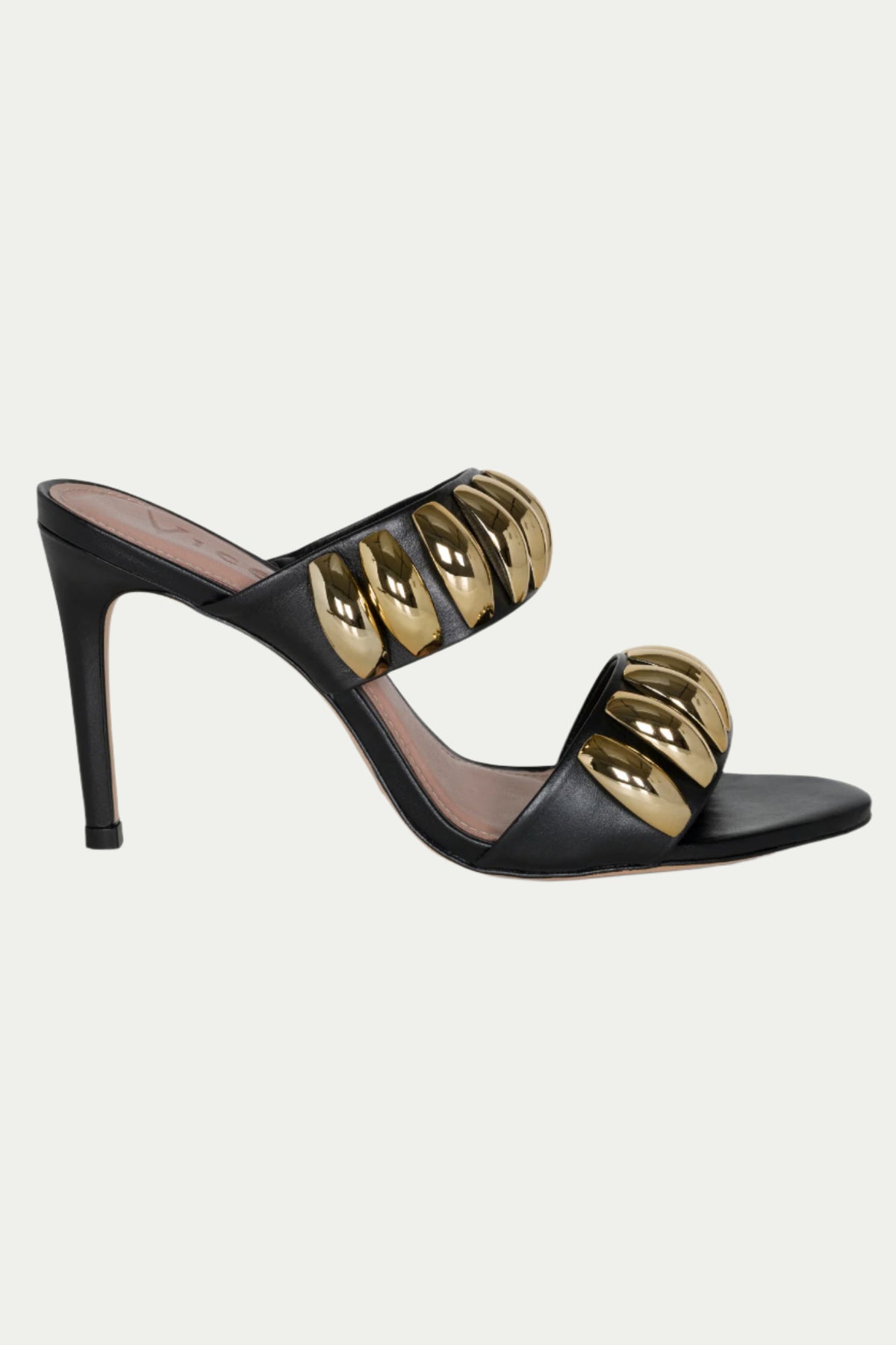 The GOLDEN VOLUME HEEL SANDAL is a black and gold slip-on with two wide straps, shiny gold oval accents, an open toe, and a stylish stiletto heel—ideal for elevating any evening ensemble.