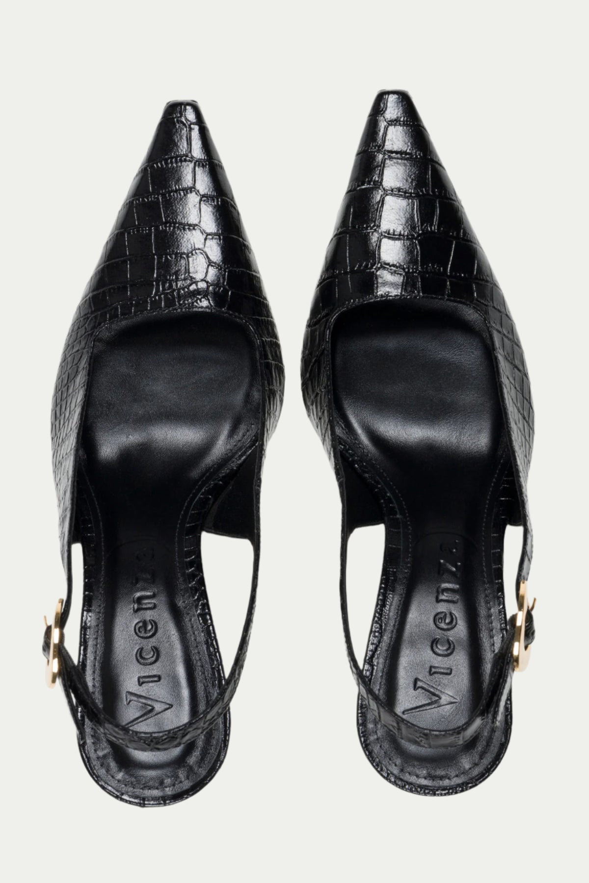 The Naomi Slingback Heel is a black, pointed-toe heel with a crocodile texture and gold buckle detail, shown from above.