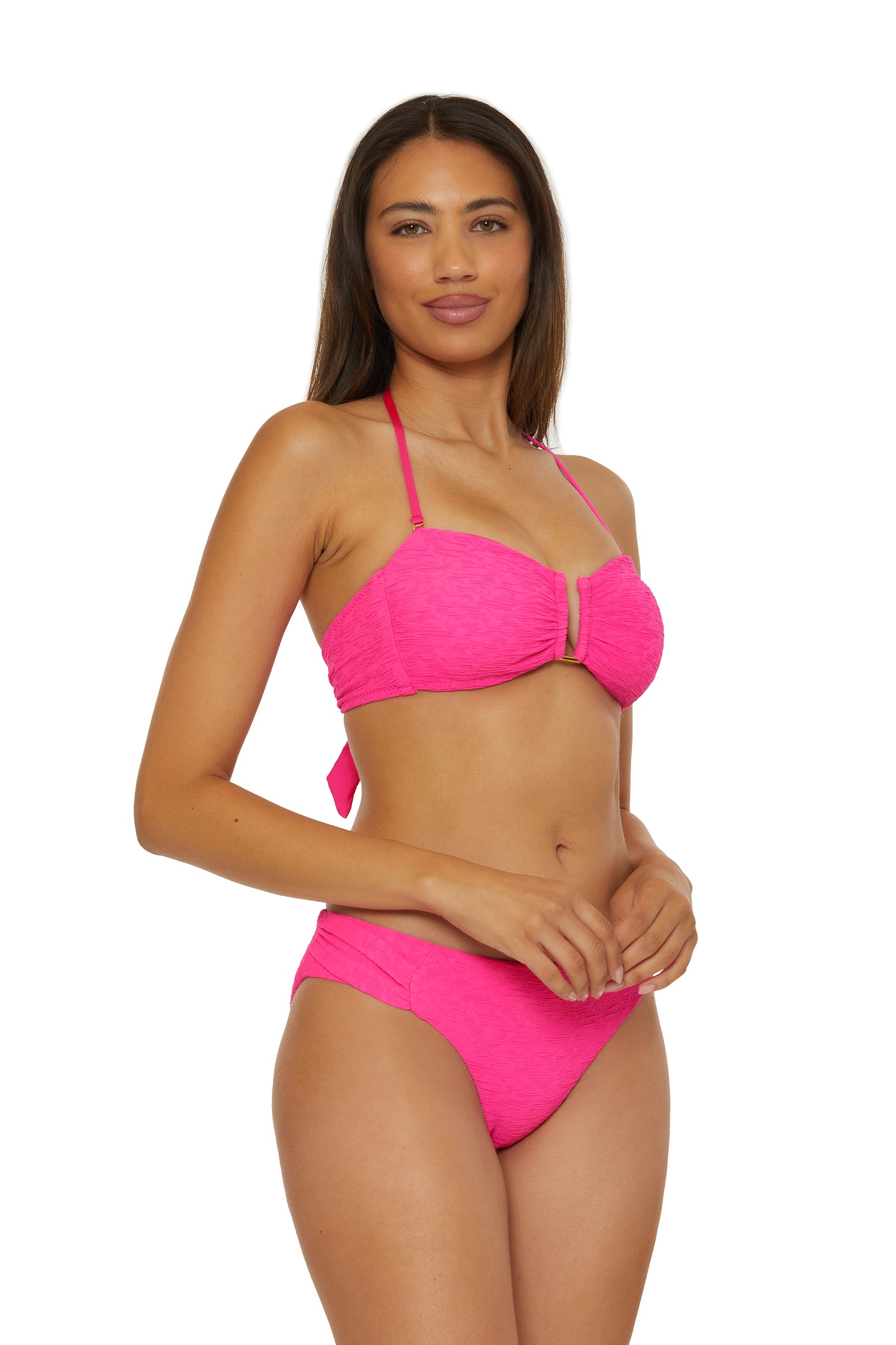 Woman with long brown hair wearing the Strapless Bandeau Swim Top - Indio, a bright pink textured bikini, standing against a plain white background.