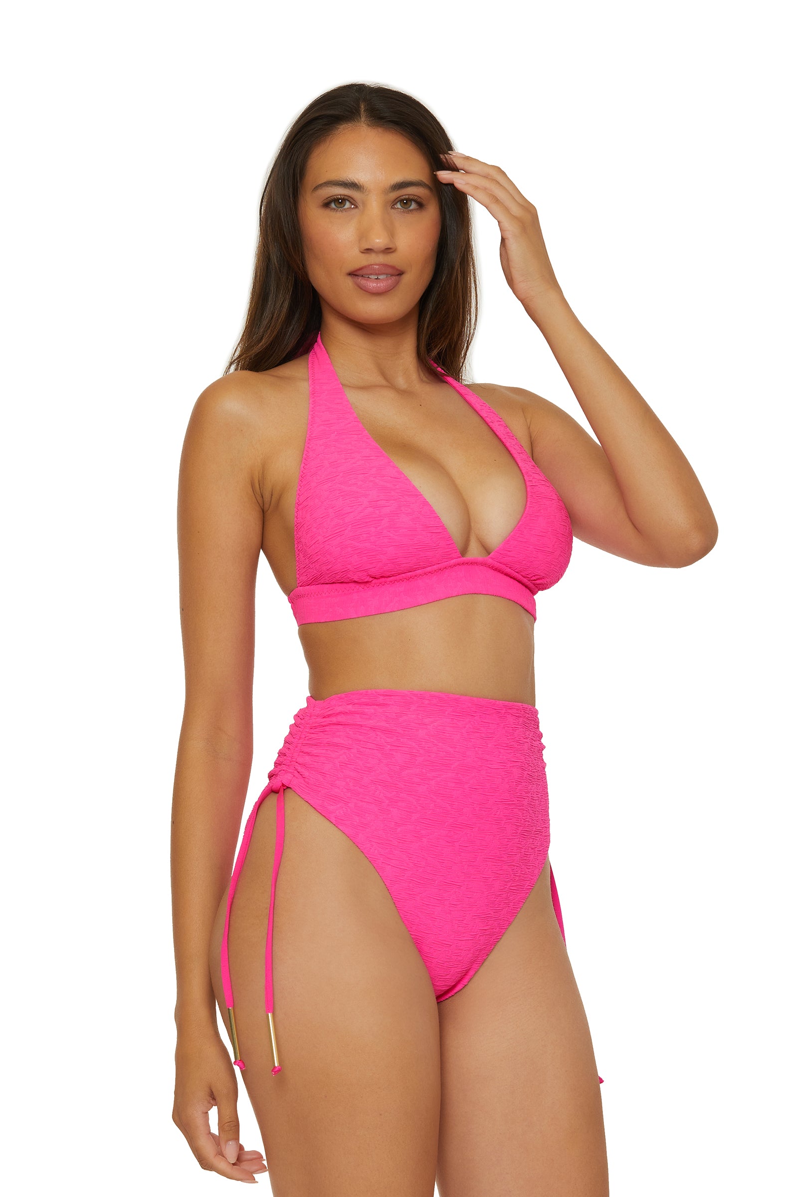 A woman poses in a bright pink bikini with a halter top and Shirred High-Waist Swim Bottom - Indio, featuring ruched tie-sides, against a plain white background.