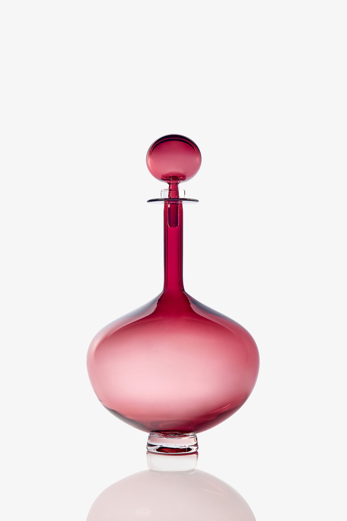 A Large Genie Bottle Decanter in rounded pink glass with a matching round stopper, displayed against a plain white background.