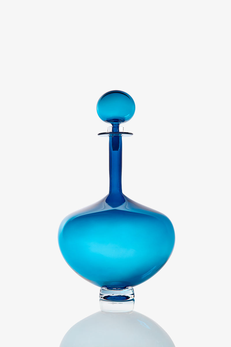 A Large Genie Bottle Decanter made of translucent blue glass with a round stopper, displayed against a plain white background.