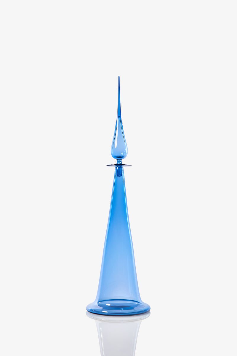 A Large Fluted Cone Decanter featuring a tall, elegant blue glass design with a wide base and a narrow, pointed tip, displayed against a white background.
